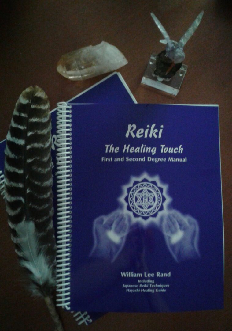 A reiki manual and feather on the table